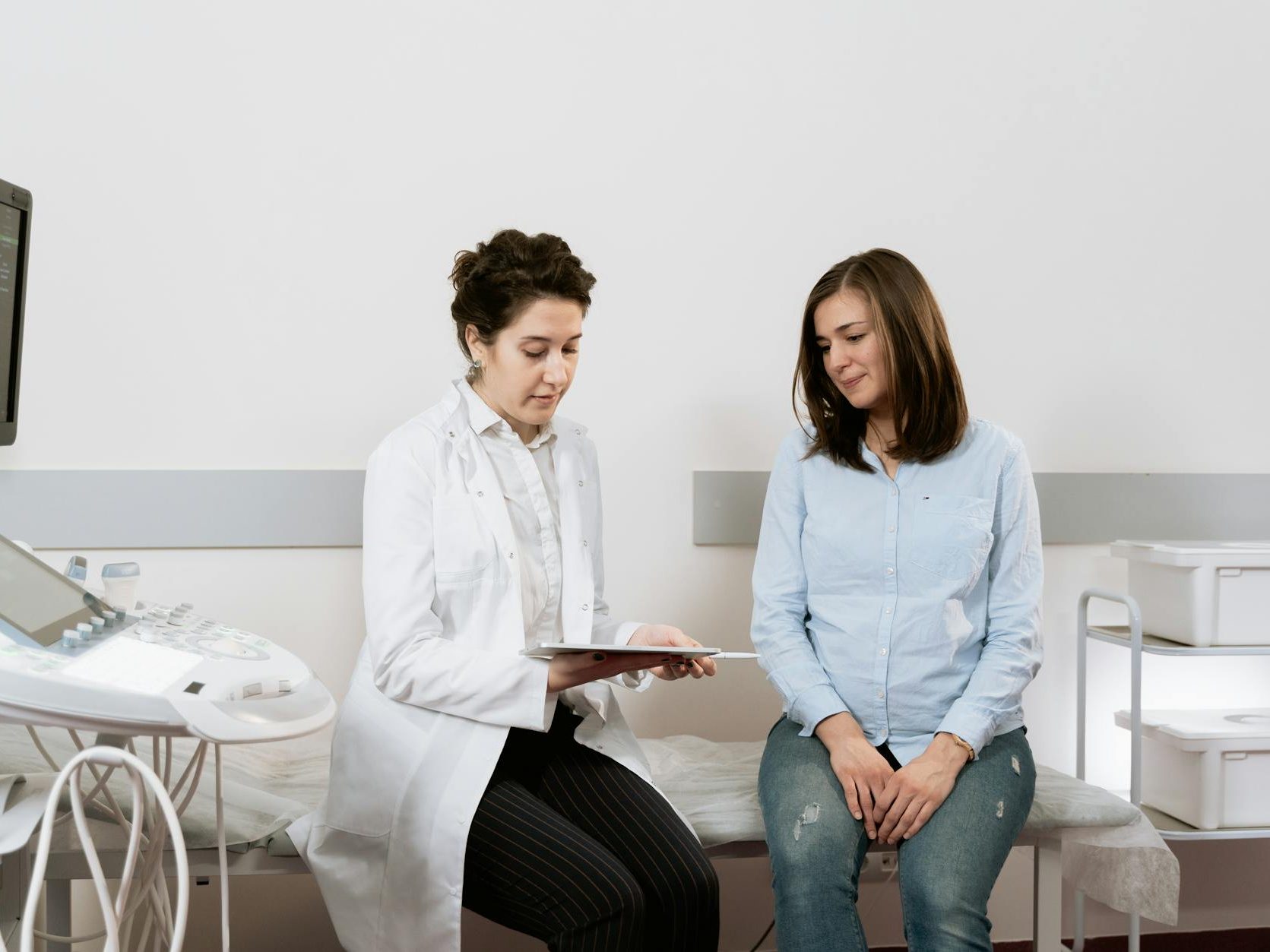 photo of pregnant woman having a consultation