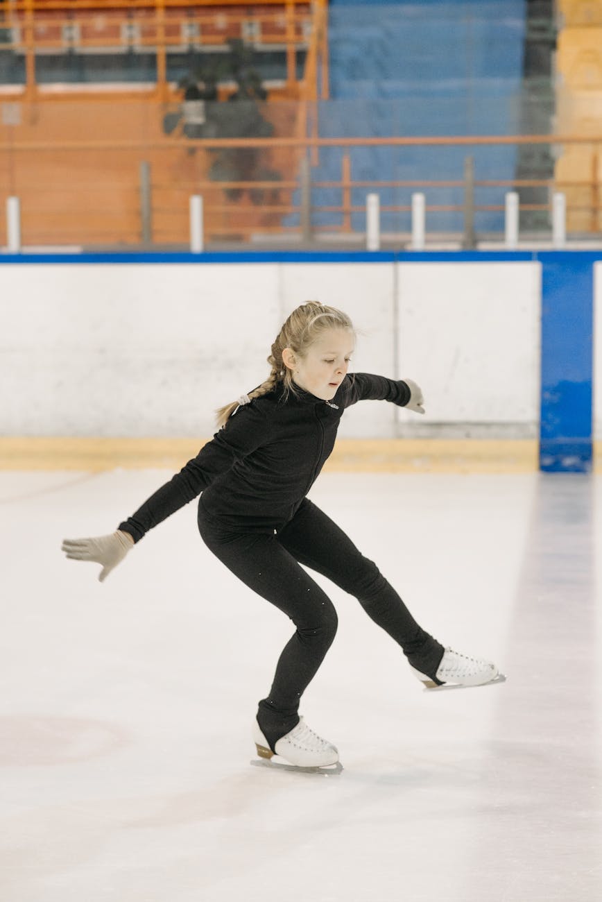 girl in black bodysuit doing figure skating